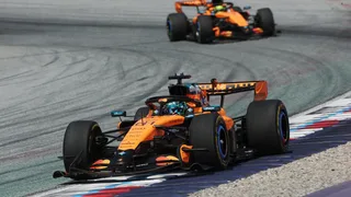 Adele tries McLaren F1 simulator in behind-the-scenes visit to headquarters